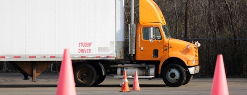 Conducteur étudiant dans un semi-camion jaune formation aux manœuvres de stationnement